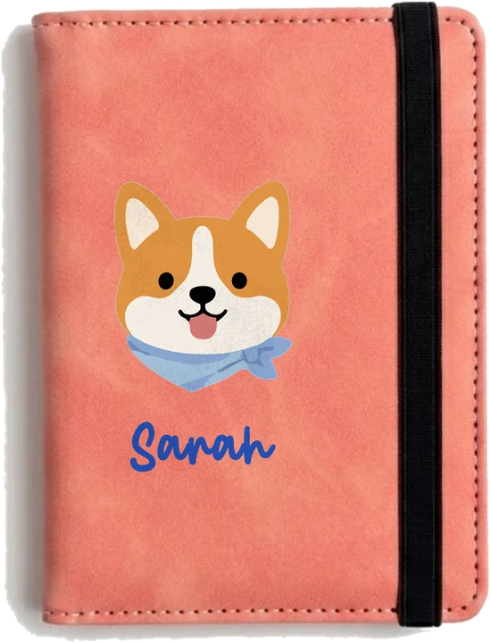 Sakura Pink leather passport holder printed with a cute corgi icon and the name Sarah